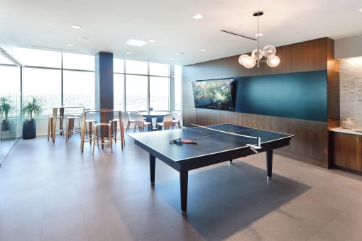 resident game room with pool and poker table at Two Twelve Clayton, Missouri, 63105
