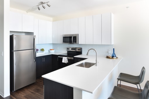 kitchen with white cabinets and quartz countertops  at Two Twelve Clayton, Clayton, Missouri