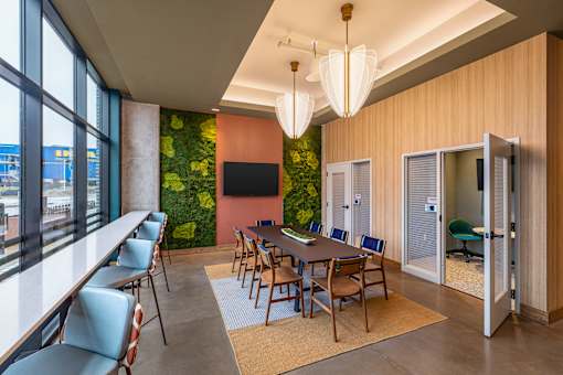 A conference room with a long table and chairs.