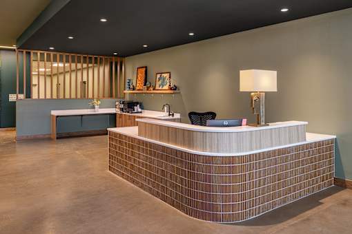 A reception area with a counter and a couch.