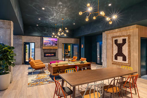 A modern dining room with a wooden table and chairs.