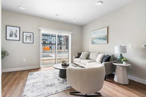 A living room with a white chair and a grey sofa.
