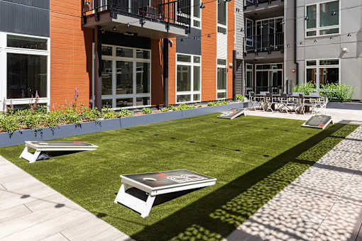 A lawn with a frisbee and a table and chairs set up on it.