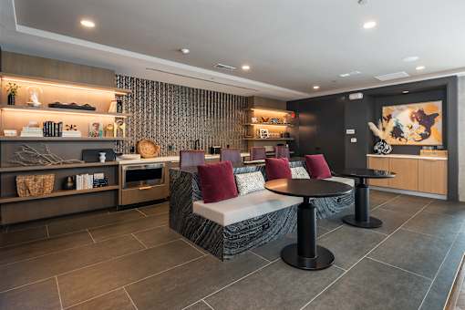 A modern living room with a grey sofa and a black coffee table.