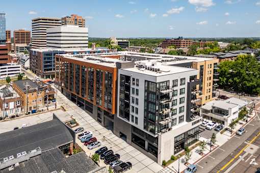 A modern building with a parking lot in front.