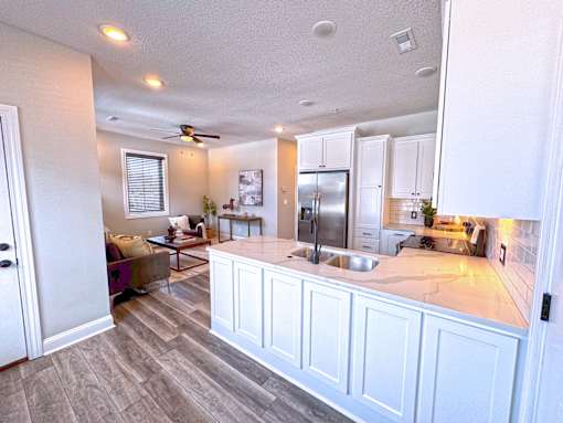 A kitchen with a countertop and a refrigerator.
