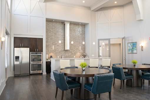 a dining room and kitchen with blue chairs and a table