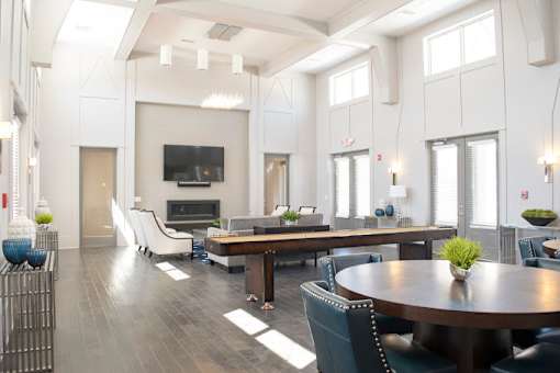 a living room with a table and chairs and a television