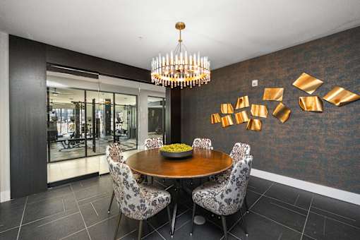 A dining room with a round table and chairs. at The Cunningham Apartments, Iowa