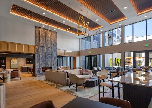 A modern living room with a large window and a wooden floor.