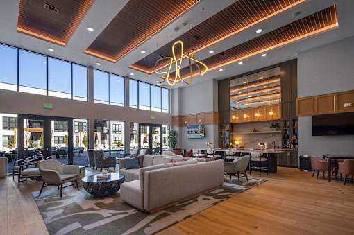 A modern living room with a large couch and a coffee table.