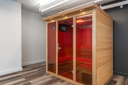 A wooden pod with a red interior is open in a room.