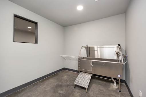A large stainless steel tank in a room with concrete flooring and white walls at The Cunningham Apartments, West Des Moines, 50266