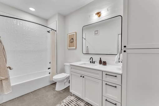 Bathroom with mirror at Plaza at Pinnacle Hills, Rogers, AR