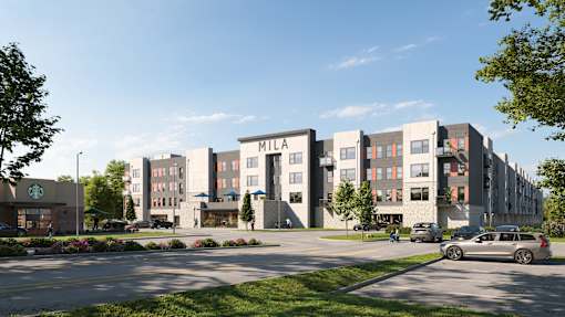 A modern apartment complex with a Starbucks in the foreground at Mila Apartments, Ellisville, Missouri
