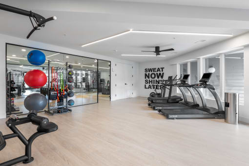 the gym is equipped with treadmills and other fitness equipment at The Flats & Terraces at Wildhorse Village, Chesterfield