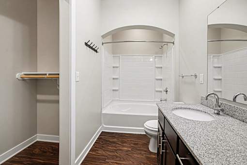 A bathroom with a toilet, sink, and bathtub.