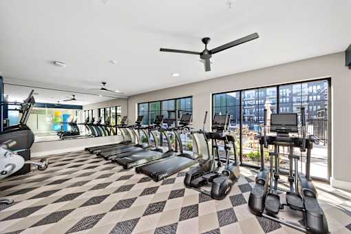 A gym with treadmills and elliptical machines. at The Cunningham Apartments, Apartments, West Des Moines, IA