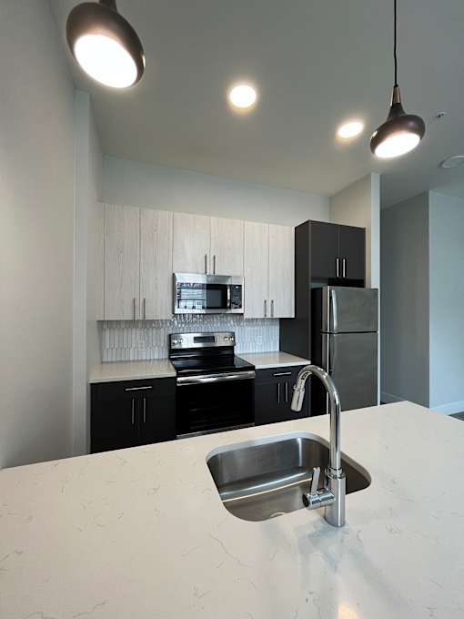 A modern kitchen with a sink and cabinets.