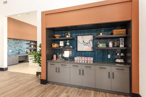 A kitchen with a wooden floor and a wall with a shelf at Montage at Hawk Ridge Apartments, Lake St. Louis, Missouri
