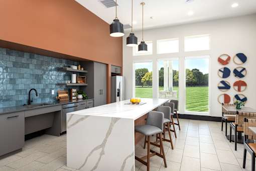 A kitchen with a marble island and a view of the backyard at Montage at Hawk Ridge Apartments, Lake St. Louis, 63367, MO