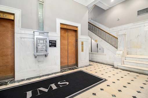 A black and white tiled floor with the letters "JMS" on it.