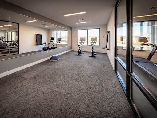 A spacious gym with a variety of exercise equipment.