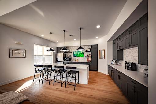 A kitchen with a bar area and a dining table.