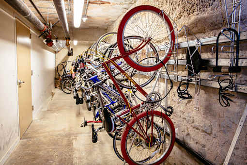 several bikes hanging on a wall at Residences at Forest Park, Saint Louis, MO, 63108
