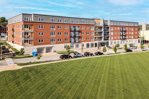 A large building with a green lawn in front.