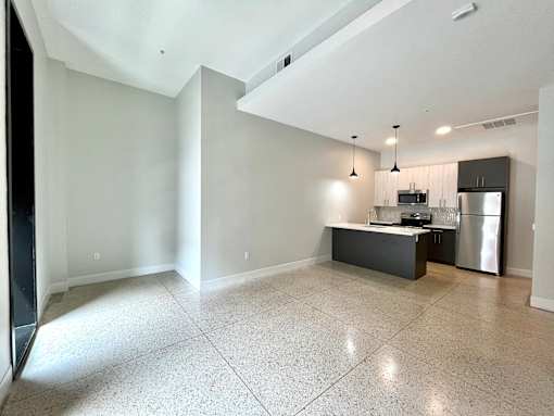 A kitchen area with a refrigerator, microwave, and oven.