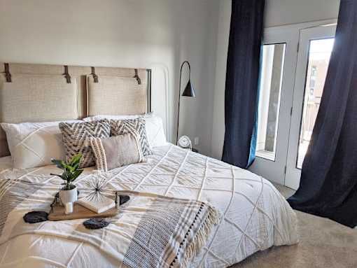 a bedroom with a bed and a window at GrandView Flats and Townhomes, Indiana