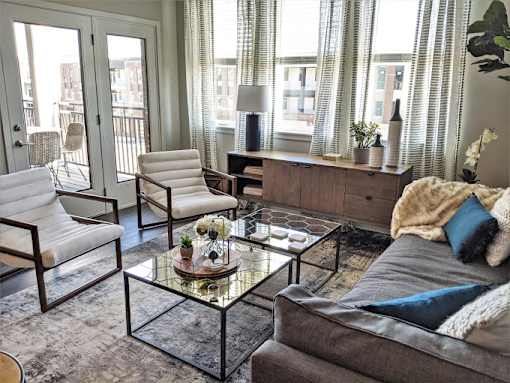 a living room filled with furniture and a glass table at GrandView Flats and Townhomes, Indiana