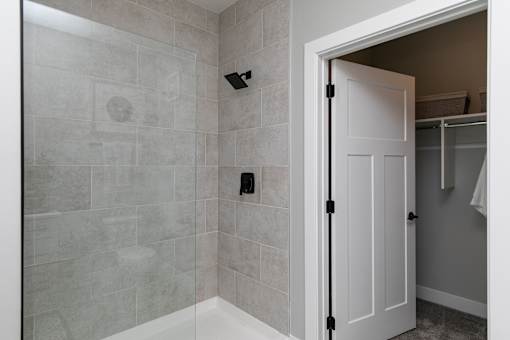 A white door is open to a bathroom at The Cunningham Apartments, Apartments, West Des Moines, IA