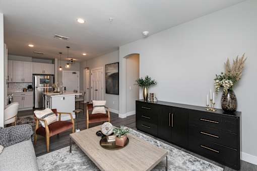 A modern living room with a wooden coffee table and a black cabinet. at The Cunningham Apartments, Iowa