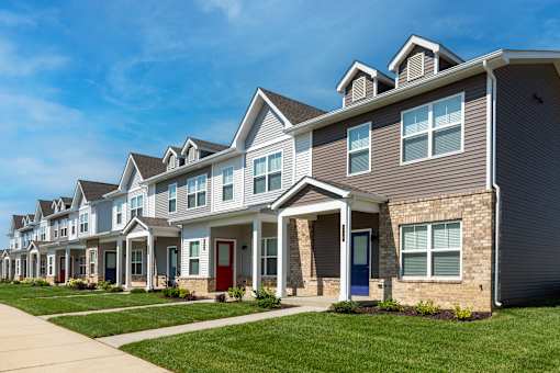 A row of houses with blue doors and windows.