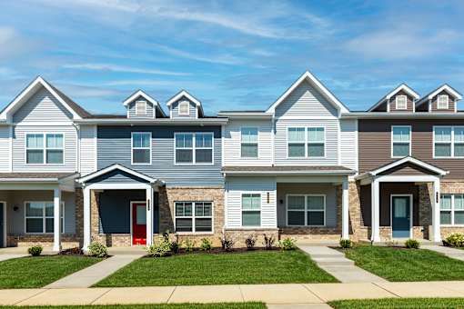 A row of houses with red and blue doors.