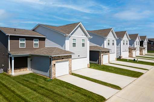 A row of houses with garages in front.