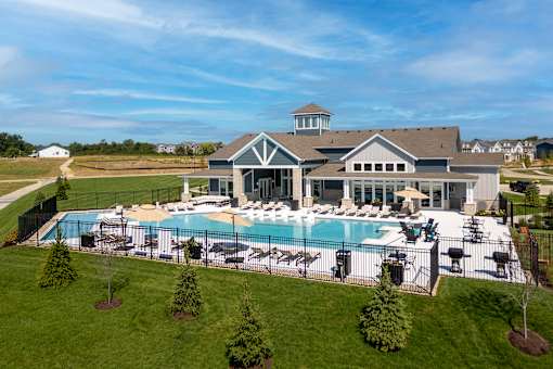 A large house with a pool in the backyard.