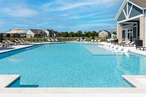A large swimming pool with a building on the right side.