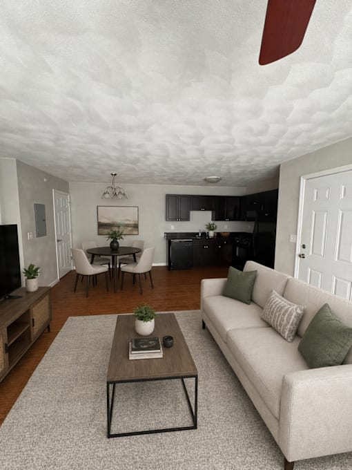 A living room with a white couch and a coffee table.