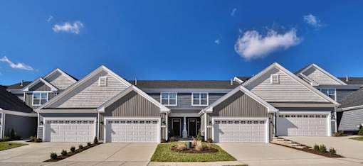 A row of houses with garages in front.