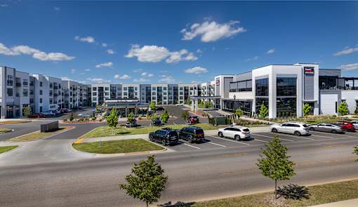 A parking lot with cars and a building in the background.
