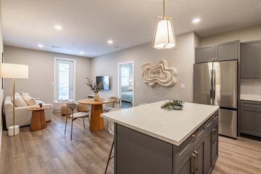 A modern kitchen with a white island and stainless steel appliances.at Preserve at Sycamore Creek, Osage Beach, MO 65065