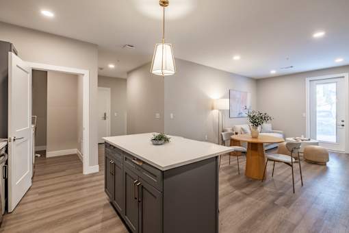 A modern kitchen with a large island and a dining area.at Sycamore Creek, Osage Beach, MO 65065