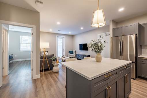 A modern kitchen with a large island and stainless steel appliances.at Preserve at Sycamore Creek, Osage Beach, MO
