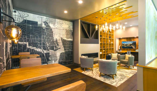 a restaurant with a large mural on the wall and chairs and tables at The Rail, St. Louis