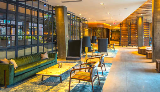 a lobby of a hotel with couches and tables and chairs at The Rail, St. Louis Missouri