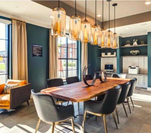 a dining room with blue walls and a wooden table and chairs at The Rail, St. Louis, 63110