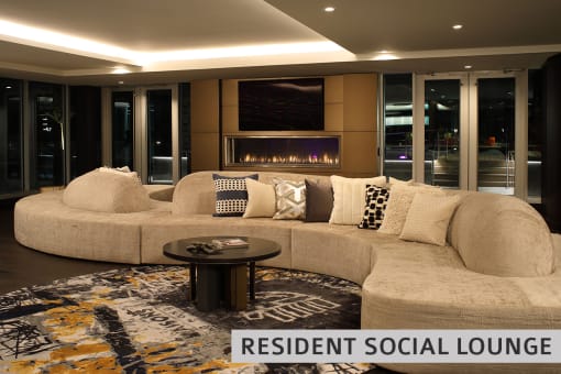 a living room with a large couch and a fireplace  at Expo at Forest Park, Missouri, 63112